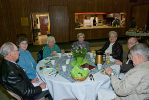 Easter Breakfast - Church Members Sitting Around Table