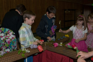 Our kids putting flowers on the cross