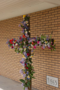 Wood Cross with Flowers that our kids placed on it.