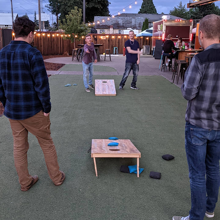 Young adults play games at the Yard Food Park