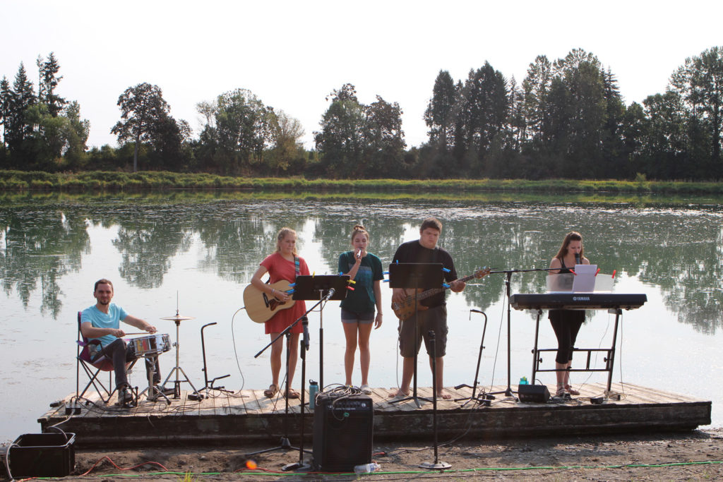 Worship team leads worship from the dock 