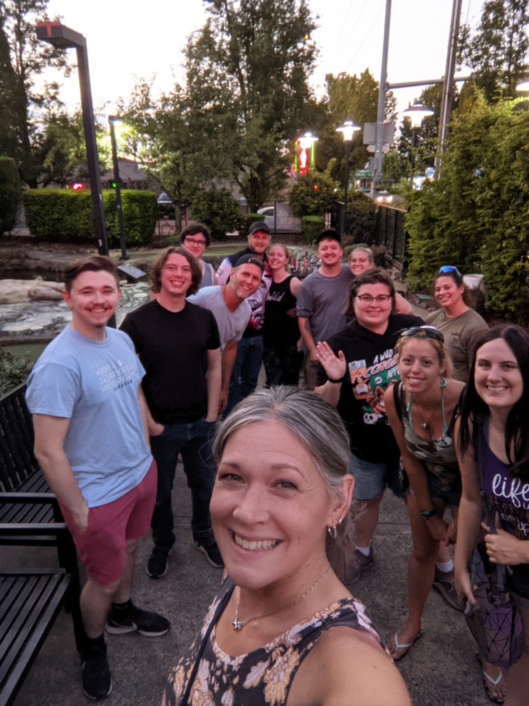 Group of smiling young adults gathered to play mini golf